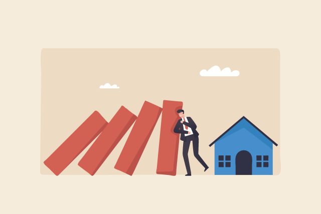 Housing crisis, a real estate marketplace for distressed properties The slowdown in real estate prices Businessman stops a domino effect to protect a house